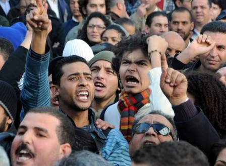 People chant during a demonstration in Tunis, Tunisia, against high prices and unemployment, Saturday Jan.8, 2011. Witnesses say five people were injured after security forces opened fire on protesters during another street demonstration over high unemployment in central Tunisia. One witness, a union official, says a police officer also was injured in the protest in Saida in which demonstrators set fire to tires and threw stones in the latest in three weeks of unrest.(AP Photo/Hassene Dridi)